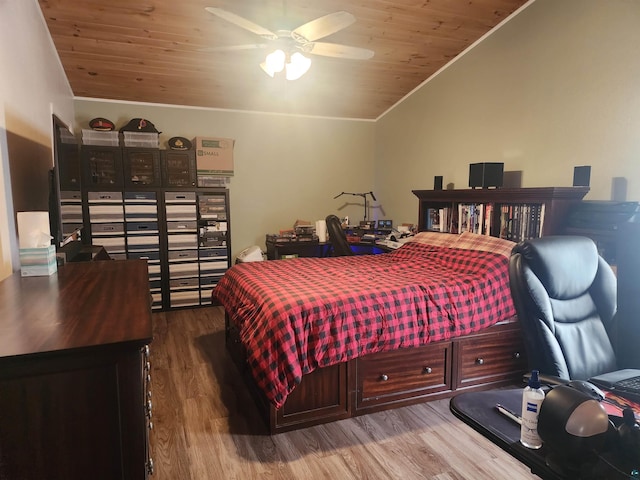 bedroom with crown molding, wood ceiling, vaulted ceiling, and wood finished floors