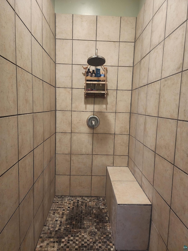 bathroom with tiled shower