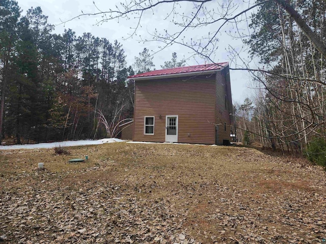 view of property exterior with metal roof