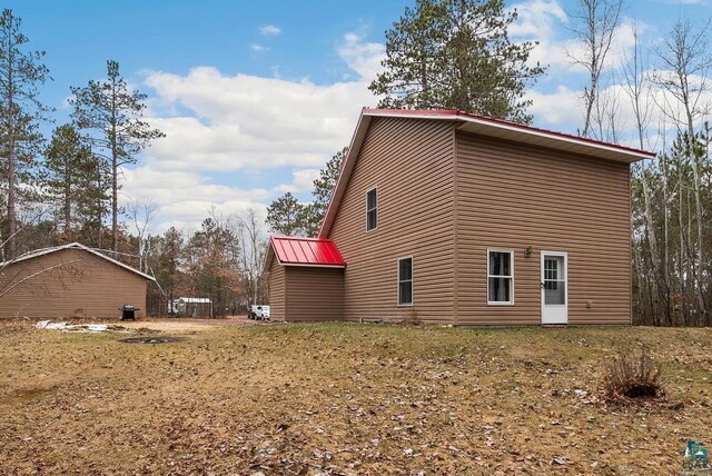 view of side of home with metal roof