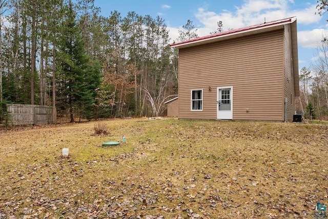 back of property with fence and central AC unit