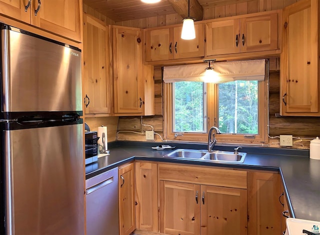 8352 Old Gunflint Trl, Grand Marais, MN 55604 - kitchen with light brown cabinets, a sink, dark countertops, appliances with stainless steel finishes, and wooden ceiling