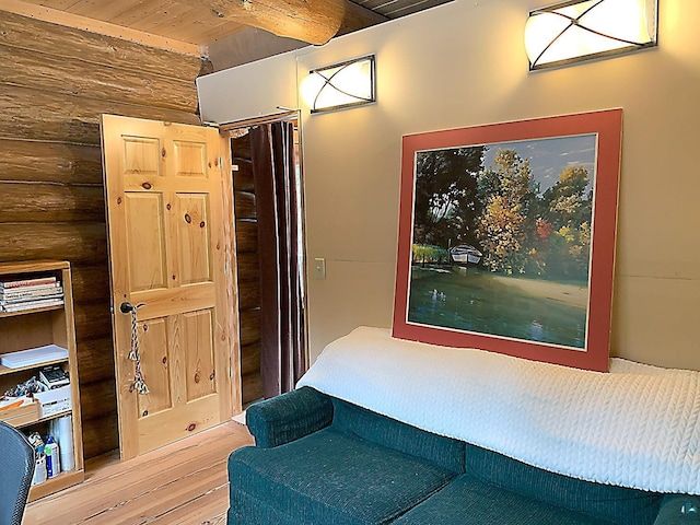 8352 Old Gunflint Trl, Grand Marais, MN 55604 - bedroom featuring rustic walls, wood finished floors, beamed ceiling, and wooden ceiling