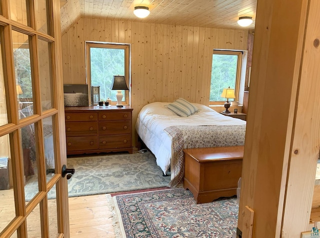 8352 Old Gunflint Trl, Grand Marais, MN 55604 - bedroom with wood walls, hardwood / wood-style flooring, vaulted ceiling, and wood ceiling
