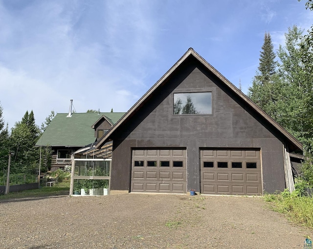 8352 Old Gunflint Trl, Grand Marais, MN 55604 - view of front of property with a garage and dirt driveway