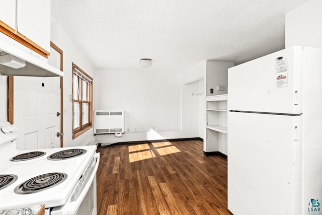 kitchen with white appliances, white cabinets, under cabinet range hood, dark wood-style flooring, and heating unit