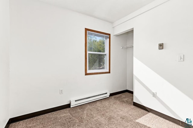 unfurnished bedroom featuring a baseboard radiator, a closet, carpet flooring, and baseboards
