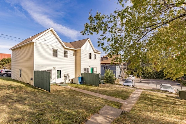 view of side of property with a yard