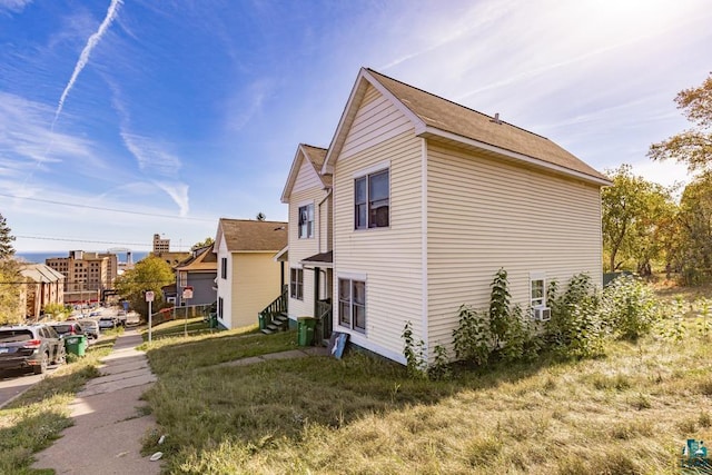 view of side of property featuring entry steps