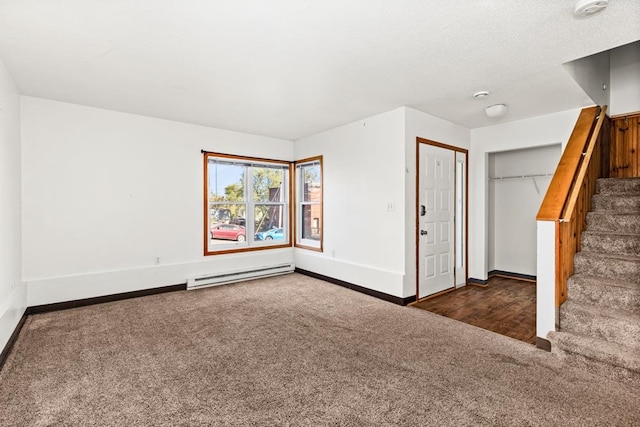 interior space featuring stairs, carpet flooring, baseboard heating, and baseboards