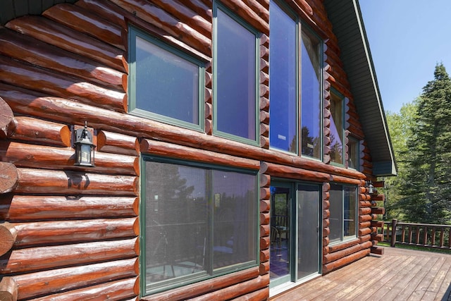 view of home's exterior featuring log siding and a deck