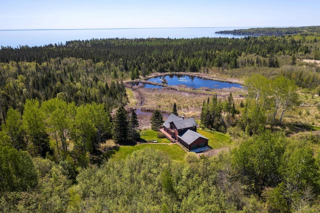 aerial view featuring a view of trees and a water view
