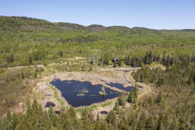 aerial view with a wooded view and a water view