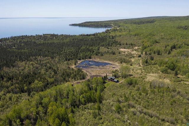aerial view with a wooded view and a water view