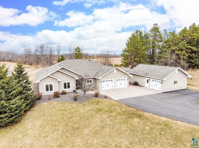 single story home with an attached garage, driveway, and a front lawn