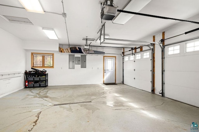 garage with electric panel and a garage door opener