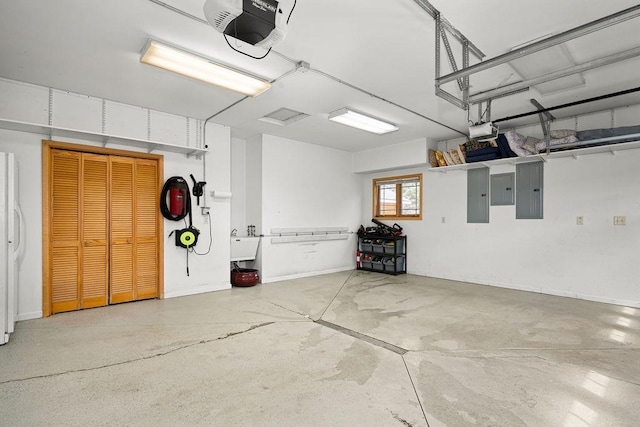 garage featuring a garage door opener, a sink, and electric panel