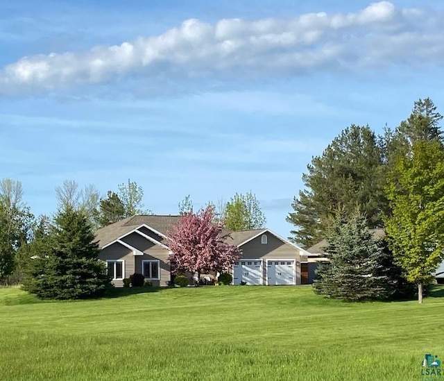 exterior space featuring an attached garage and a front lawn