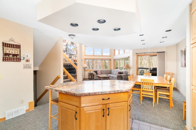 kitchen featuring baseboards, light carpet, visible vents, and recessed lighting