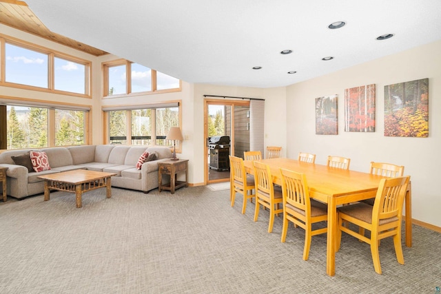 dining area with baseboards, recessed lighting, and light colored carpet