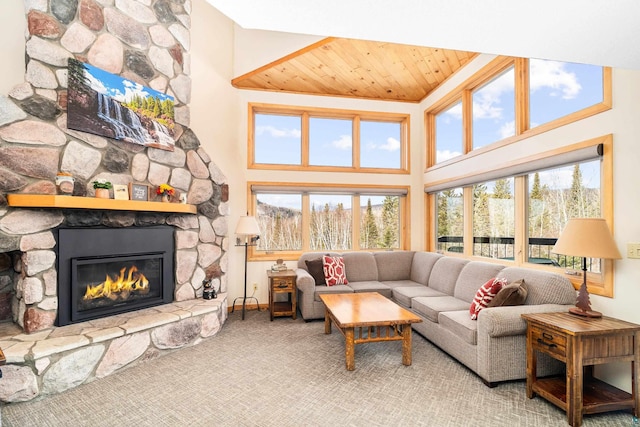 living area featuring a fireplace, baseboards, a towering ceiling, and wood ceiling