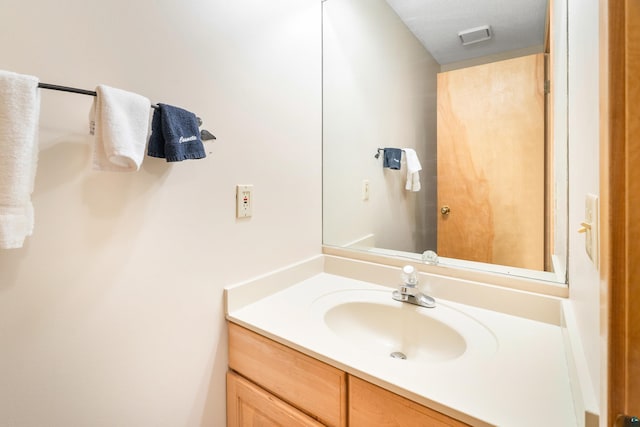 bathroom with visible vents and vanity