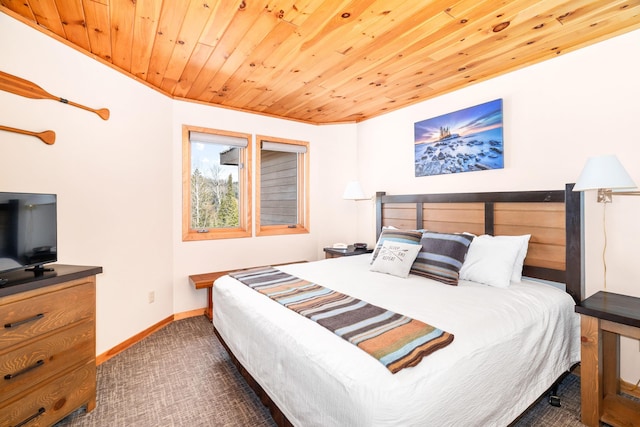 bedroom featuring wood ceiling, baseboards, and dark carpet
