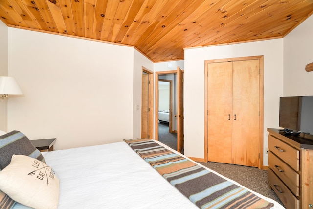 carpeted bedroom featuring a closet and wooden ceiling