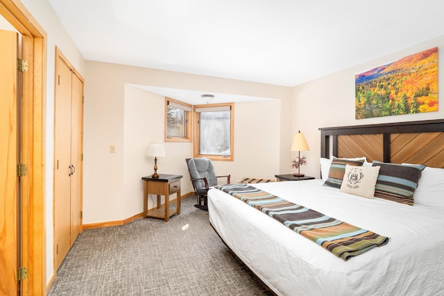 bedroom with carpet floors and baseboards