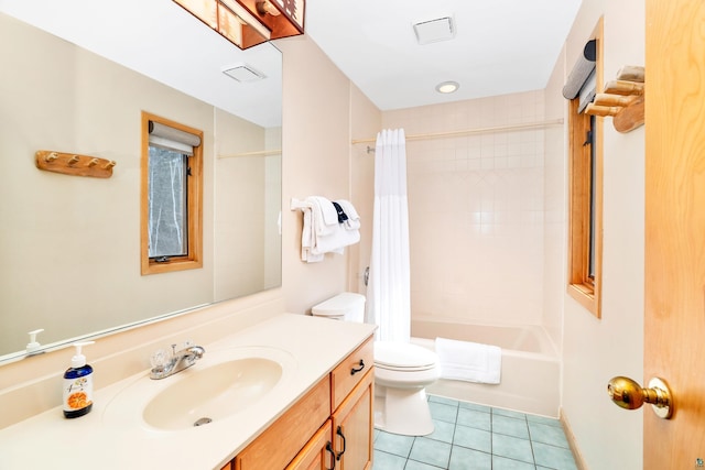 full bathroom with tile patterned floors, shower / bath combo with shower curtain, vanity, and toilet