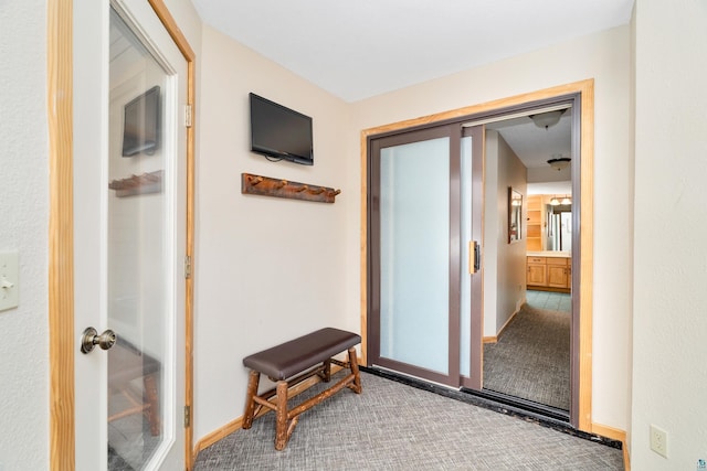 hall with carpet floors and baseboards