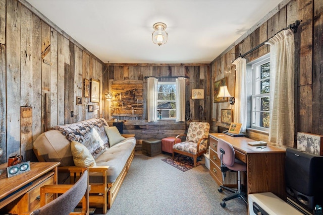 living area with wood walls and carpet flooring