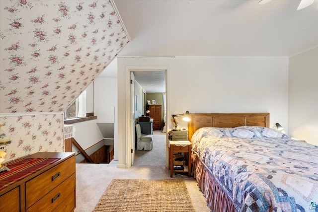 bedroom with light colored carpet and baseboards