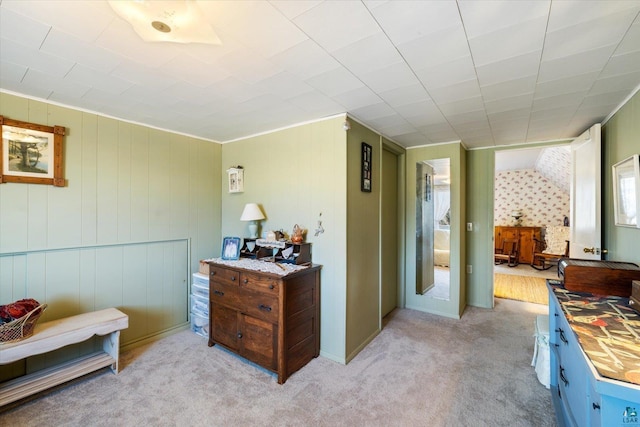 hallway with light colored carpet and crown molding