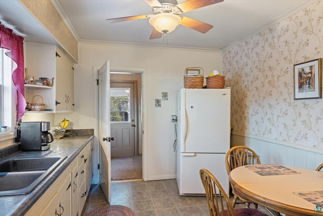 kitchen with crown molding, open shelves, a sink, ceiling fan, and freestanding refrigerator