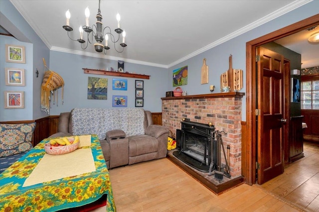 interior space featuring wainscoting, hardwood / wood-style flooring, a notable chandelier, and ornamental molding