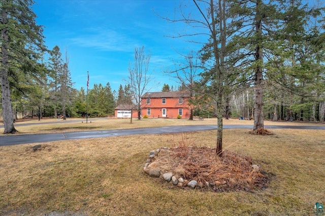 view of yard featuring curved driveway