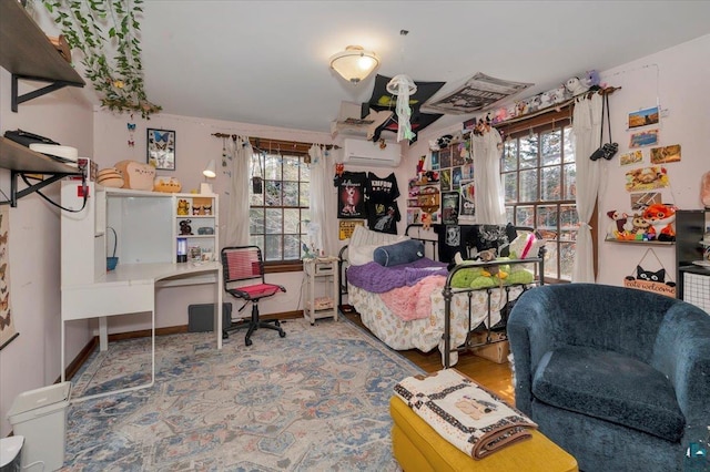 bedroom featuring an AC wall unit and multiple windows