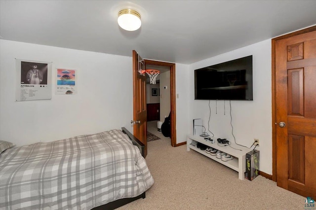 bedroom featuring baseboards and light colored carpet