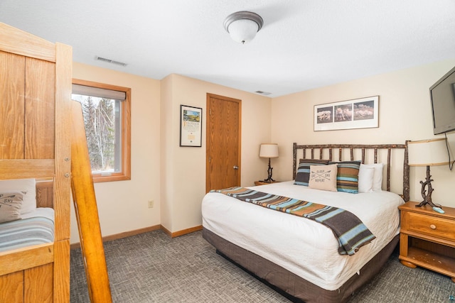 bedroom with carpet floors, visible vents, and baseboards
