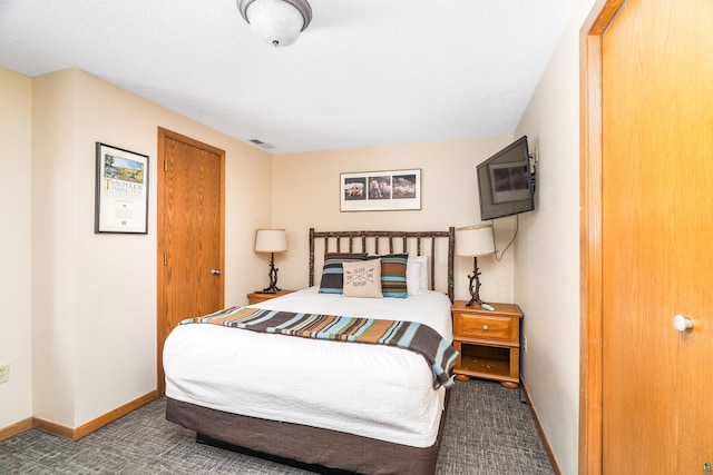 carpeted bedroom with visible vents and baseboards
