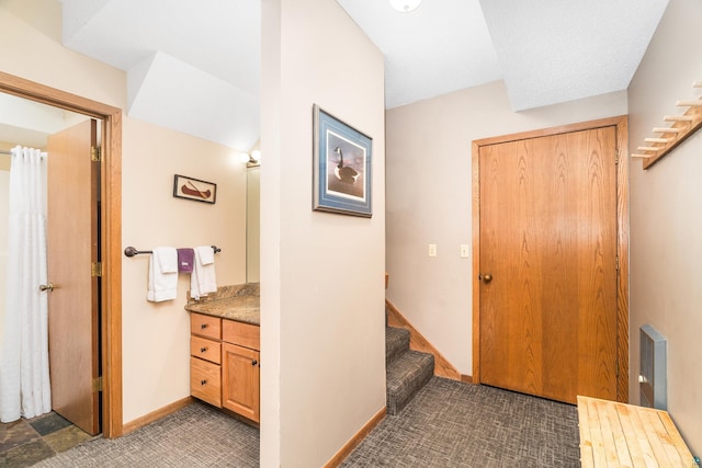 interior space with baseboards and stairway