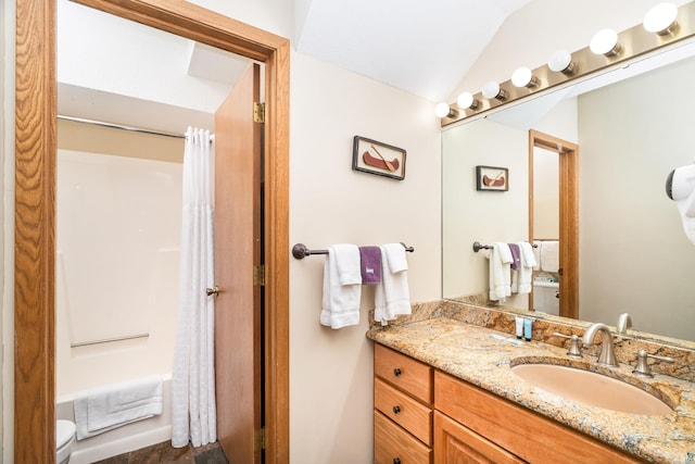 full bath featuring lofted ceiling, vanity, shower / bath combination with curtain, and toilet