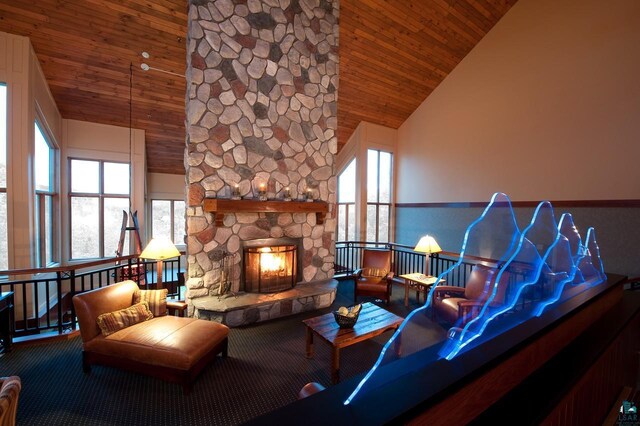 sitting room featuring wooden ceiling, high vaulted ceiling, and a fireplace