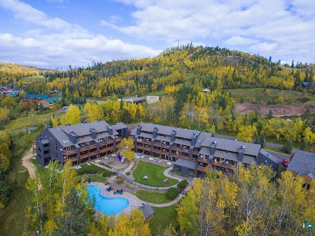 drone / aerial view featuring a view of trees