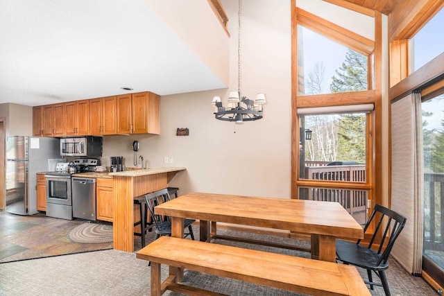 kitchen with light countertops, a chandelier, and appliances with stainless steel finishes