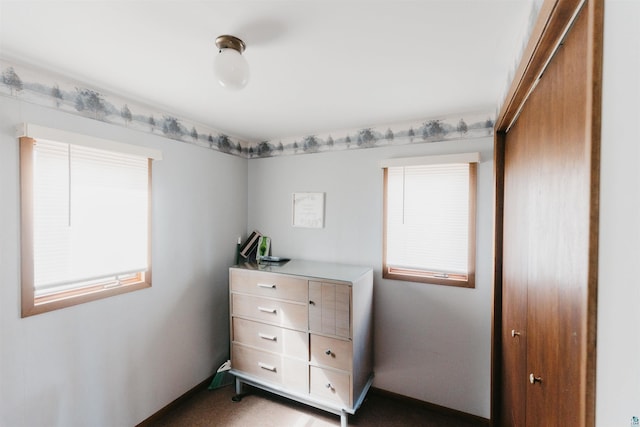 bedroom with carpet floors and baseboards