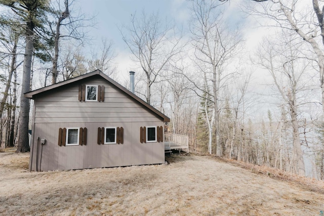 view of side of property with a wooden deck