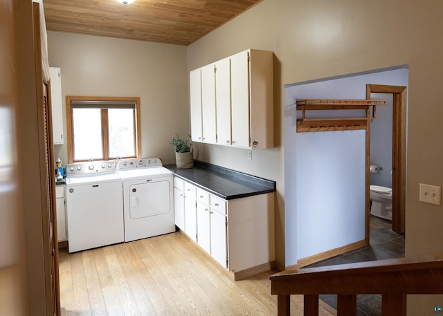 washroom with wooden ceiling, cabinet space, light wood-style floors, and independent washer and dryer