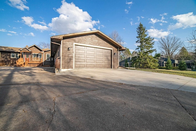 exterior space featuring concrete driveway and a garage